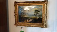 Frontal view of framed landscape painting hung on wall