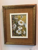 Framed floral painting showing the overall presentation of the artwork including the frames and textured matting.