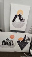 Three abstract nature themed art prints arranged with shapes and orange sun motifs.