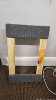 Overall view of the 4-wheel dolly showing wooden frame and carpet padding