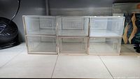 6 clear plastic shoe boxes arranged in 2 rows, 3 boxes each, showing stacked storage configuration.