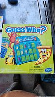 Box of Hasbro Guess Who? board game showing colorful characters and branding.