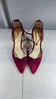 Front view of pair of pink suede Jessica Simpson heels with pointed toe and ankle strap