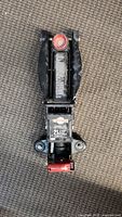 Top view of the Motomaster hydraulic car jack showing the lifting arm and red adjustment knob.