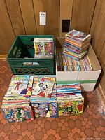 Overall piles of numerous Archie comics in used but good condition packed in three containers: a green crate, a white box, and loose sets on the floor.