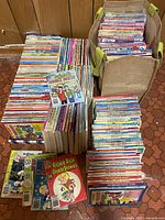 Wide view showing stacks of assorted Archie Comics including Archie Double Digest, Jughead's Double Digest, Richie Rich Digest Stories, and others arranged on the floor and inside a fabric basket.