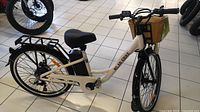 Full side view of white Daymak Milan electric bike showing frame, battery, basket, rack and wheels