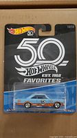 Front of the Hot Wheels packaging showing the blue and orange '65 Ford Galaxie model and 50th Anniversary branding.