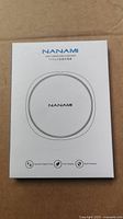 Front of the sealed packaging box showing Nanami fast wireless charger image and branding
