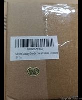 Photo of plain brown cardboard box with label indicating silicone massage cup set for neck cellulite treatment and Made in China mark.