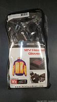Front view of the original packaging showing Venture Heat branding, Grand Touring 12V Heated Gloves model, and heating technology details.
