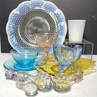 Photo showing entire lot including all glass items and bottle stoppers from front angle