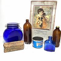 Photo showing all items: cobalt blue glass jar, medicine bottles, sharpening stone, coffee tin, glass medicine cup, Blue Coal ad,