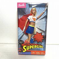 Full front view of 2003 Mattel Barbie Supergirl doll in clear display box showing doll and packaging.