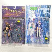 Front view of two new in box action figures: The Darkness Magdalena and Dark Angel Yuki in original packaging.