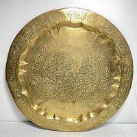 Top view of the large solid brass tray showing the entire etched floral and geometric pattern within a scalloped edge.