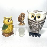 Front view of four owl figurines showing size and design details.