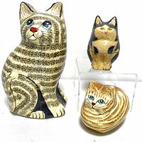 Large striped handmade papier-mâché cat figurine alongside two small cat jewelry boxes, showing detailed painting and craftsmanship.