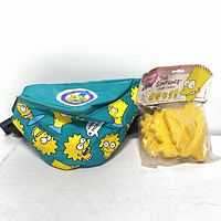 Photo of teal Simpsons fanny pack next to sealed 1990 yellow plastic Simpsons cookie cutters.