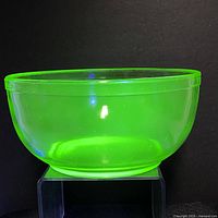 Clear view of the 7-inch uranium glass mixing bowl under black light showing its green glow.