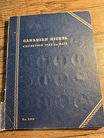 Front cover of blue vinyl album with gold stamped title and border