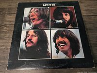 Front cover of The Beatles 'Let It Be' vinyl album featuring individual square portraits of band members John Lennon, Paul McCartney, George Harrison, and Ringo Starr on a black background.