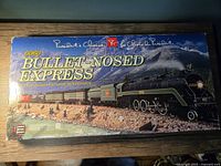 Top view of the original box showing President's Choice branding and artwork of the Bullet-Nosed Express train in mountainous terrain.