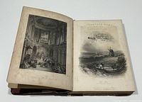 Open book showing a detailed black and white engraving on left page and decorative title page 'Picturesque Annual 1839' on right page. Visible aging, foxing on pages.