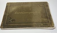 Closed olive cloth-bound portfolio showing gilt title “English Landscapes and Views.”