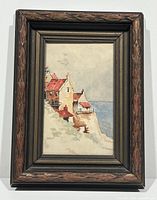 Full view of the antique framed watercolour painting showing coastal houses on cliff and sea background.