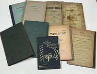 Overview photo showing all 10 Judaica books arranged together, various colors and states visible.