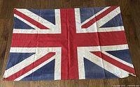 Full view of the vintage Union Jack flag with visible creases and fabric texture.