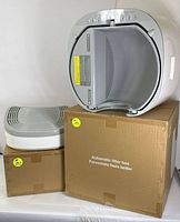 View of assembled litter box and ramp on top of packaging boxes