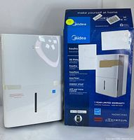 Unit and retail box side by side showing model name and branding