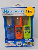 Three Midland X-Talker T10X3M two-way radios in green, orange, and blue displayed in original retail packaging with visible branding and features.