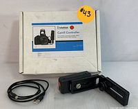 CamFi Controller device, USB cable, and original box displayed together on a flat surface