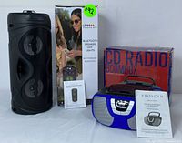 Proscan Bluetooth speaker and Proscan CD radio boombox with their original boxes and user manuals displayed on a white surface.