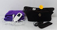 Black USB-powered heated waist belt with adjustable straps and USB cable beside purple electric heating pad and wired controller.