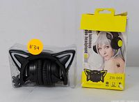 ZW-068 wireless black cat ear headphones showing glowing white cat ears in original box with cosplay model image.