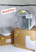 Main unit and litter tray in original boxes placed side by side