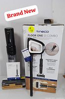 Photo of the boxed Tineco Floor One S5 Combo and main vacuum parts with product branding visible