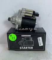 Photo of A-Premium starter motor mounted on original black box with green sticker #31.