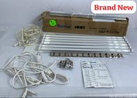 Photo showing six Barrina LED grow light strips, two white power cords, mounting clips in a plastic bag, mounting pads, instruction manual, and original box.