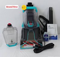 Overall view of cleaner, tank, formula bottle, attachments and manual