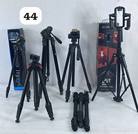 All six tripods standing upright with two original boxes included at back