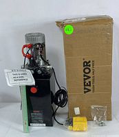 Front view of VEVOR hydraulic power unit with remote control, fittings, and original branded box. Ruler shown for size reference.