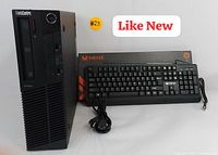 Desktop tower beside keyboard and power cord showing overall set