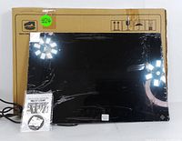 Full front view of the food warming tray in its packaging with power cord and instruction manual visible.