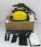 Full lot display with steam cleaner on original box, accessories laid out on white surface.