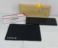 Photo showing the complete lot including boxed wireless keyboard and mouse combo, the keyboard, and ArgonX Helix gaming mouse pad